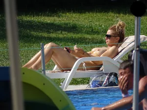 Topless lady at the pool with nice tits