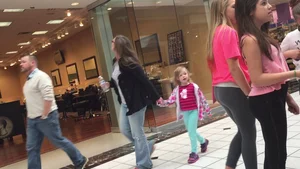 Little blonde teen in grey leggings at the mall with her friends