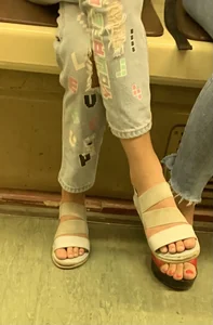 Teen Girl's Feet in Sandals in a Subway Train Photos