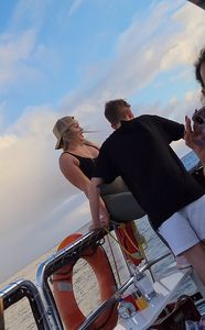Blonde bending over on a boat in leggings