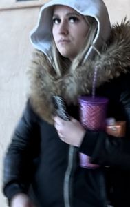 Following the blonde with Fake lashes in green leggings