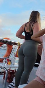 Blonde bending over on a boat in leggings