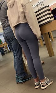 Cute girl in tight blue leggings showing off