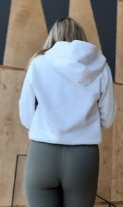 Following the blonde with Fake lashes in green leggings