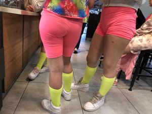 Hot chicks in pink spandex shorts and yellow socks in a cafe creepshot