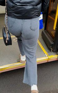 Girl in tight jeans getting on the bus, closeup of her ass