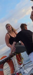 Blonde bending over on a boat in leggings