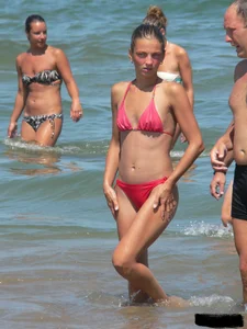 A bunch of hot babes on the beach in thong bikinis