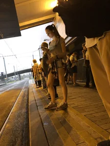 Cute Teen in Shorts on the Tram Stop