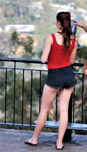 Redhead beauty in short shorts showing some cheeks and panties