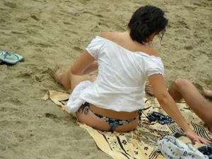 Sexy girl in a blue floral thong bikini at the beach