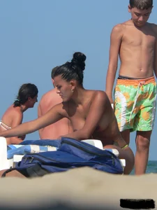 Hot ass topless beach girl with great tits lets her little brother oil up her ass in thong bikini