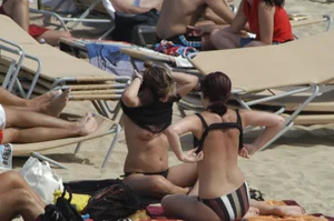 Topless girls on a beach in Barcelona