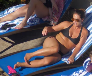 Milf laying out in black bikini by the pool