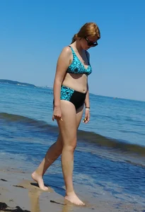 2 sexy friends in bikinis walking on the beach