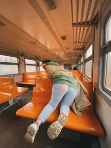 Girl in Torn Jeans Doggy Style Photo on a Seat of a Public Train