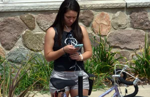 Thick brunette listening to music in shorts