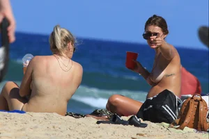 Sexy girls topless on a nude beach showing their nice tits