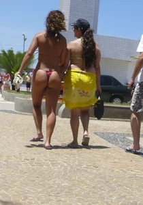 Big booty babe walking by the beach in thong