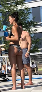 Fit brunette spotted at the pool in a cheeky bikini