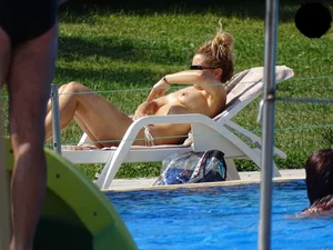 Topless lady at the pool with nice tits
