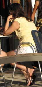 Lady in flop flops while eating showing her feet