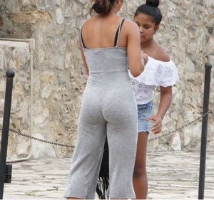 Latina with a great ass in a grey one piece outfit