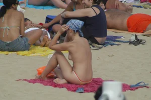 Topless girls on a beach in Barcelona
