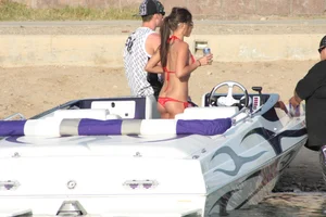 Brunette on a boat in red thong bikini with a tight little ass