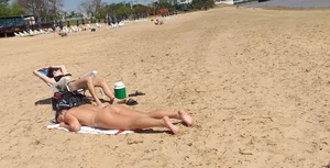 Girl laying out getting sun in a white thong bikini