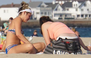 Beach babe in a blue bikini with thick friend in shorts