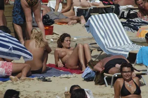 Topless girls on a beach in Barcelona