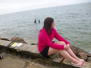 Girl in shorts chilling on the sea bank
