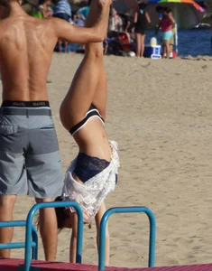 Beach teen in semi thong bikini under see through dress on the beach