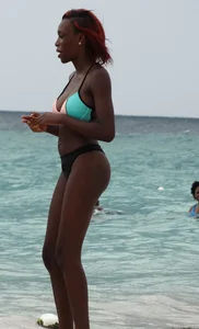Candid black family, milf and teens on the beach in bikinis
