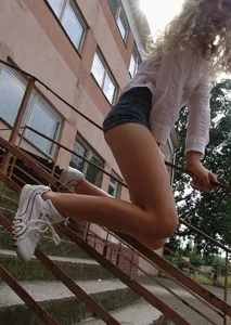 Teen JB in Mini Shorts Sitting on the Staircase Bannister