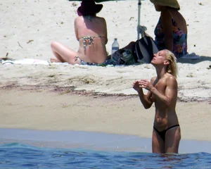 Small boobed topless milf on the beach