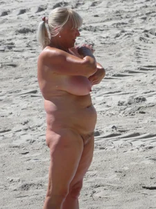 Mature blonde lady on a nude beach with big boobs