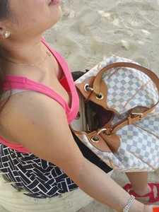 Asian chick downbloused showing nice cleavage and some bra
