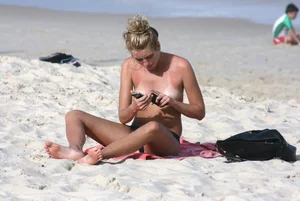 Sexy girls topless on a nude beach showing their nice tits