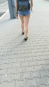 Girl walking in denim shorts showing some of her ass cheeks