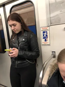 Legs in leggings subway train closeup