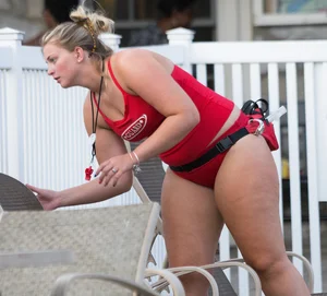 Thick blonde lifeguard in red swimsuit