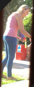 Girl wearing tight blue jeans in the backyard creepshots