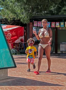 Big boobed blonde milf dancing by the pool in a bikini