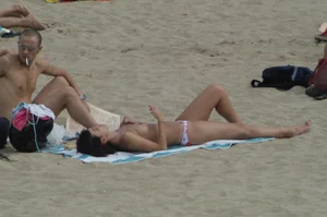 Topless girls on a beach in Barcelona