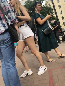 Hot Candid Girl in a Top, Shorts and Sneakers Skinny Legs Closeup Creepshots Gallery on the City Street