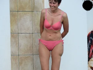 Milf at the pool in a pink bikini with camel toe