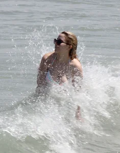 Big boobed thick blonde on the beach in a bikini