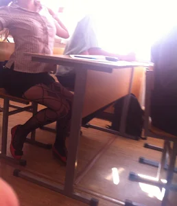 Hot college girls' legs in black pantyhose under desk in classroom creepshots